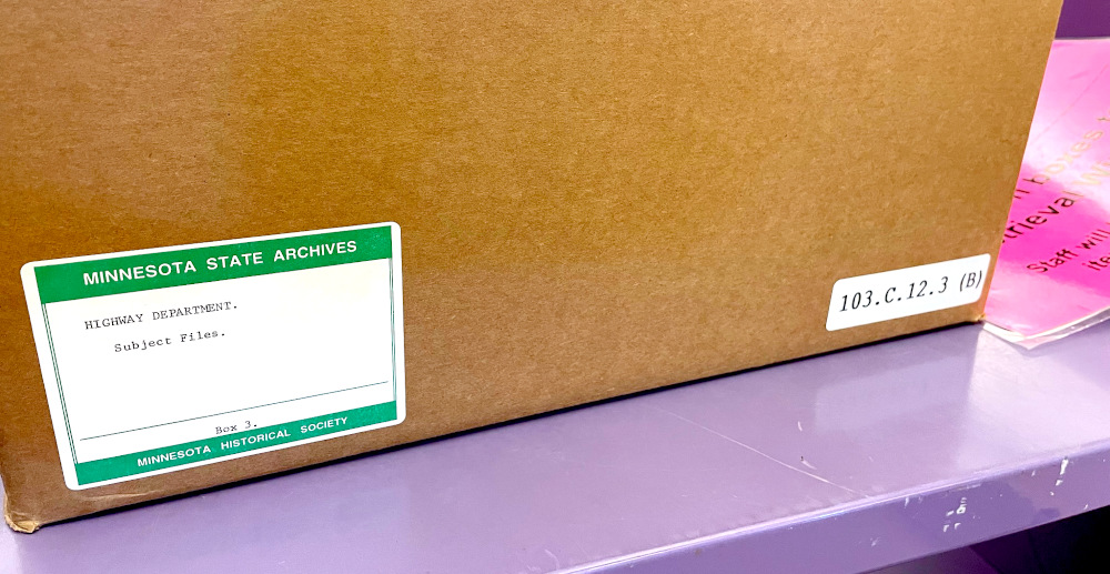 Photo of a box with a sticker that says 'Minnesota State Archives' and 'Highway Department Subject Files' on it.